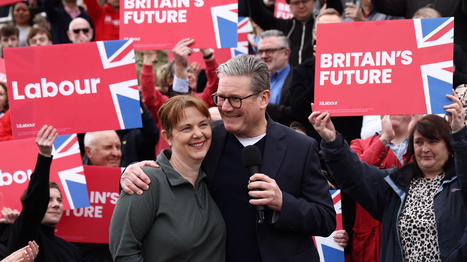 UK Labour Party leader Keir Starmer embraces newly elected East Midlands Mayor Claire Ward during a post local election rally in Mansfield, central England on 4 May 2024 (AFP/Darren Staples)