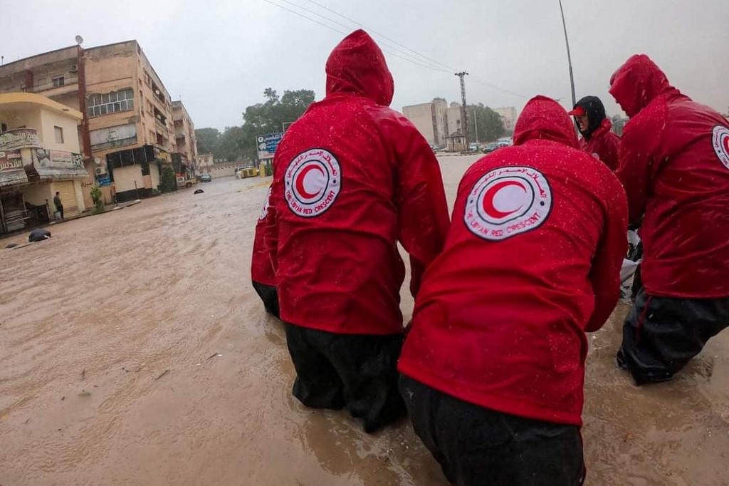 Members of the Libyan Red Crescent work on opening flooded roads in the city of al-Bayda in eastern Libya on 11 September