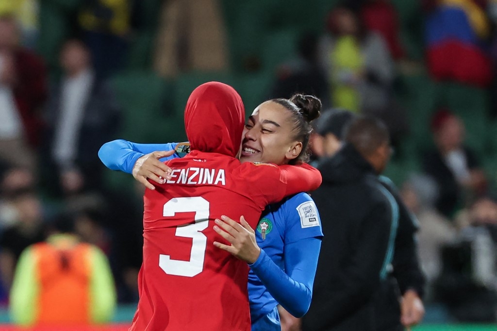 La défenseure marocaine Nouhaila Benzina (à gauche) embrasse la goal Ines Arouaissa alors que leur équipe vient de se qualifier pour les huitièmes de finale de la Coupe du monde féminine (AFP/Colin Murty)