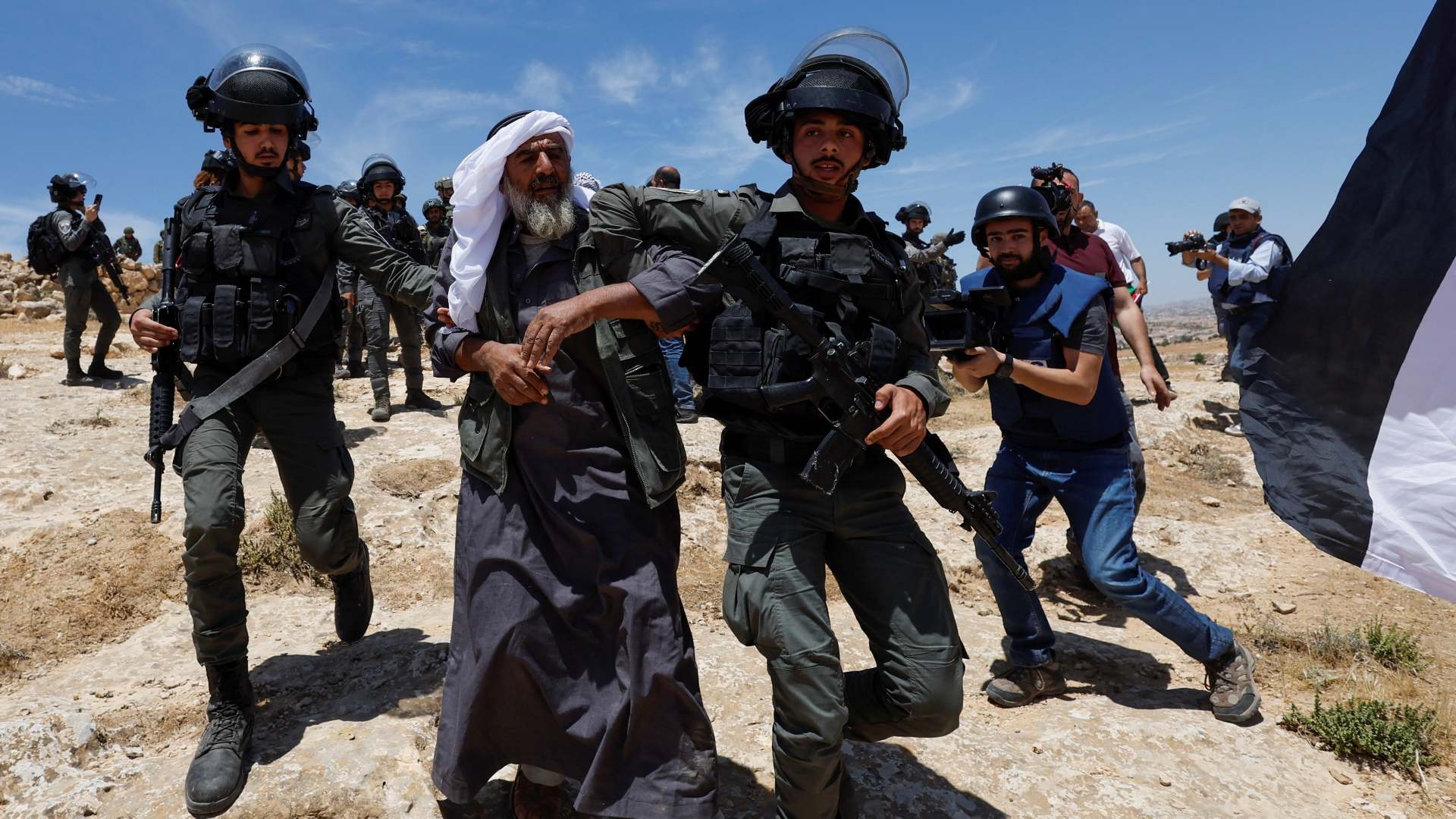 Israeli troops move away an elderly Palestinian man during a protest after Israeli top court paved way for razing eight Palestinian hamlets in Masafer Yatta in the Israeli-occupied West Bank on 20 May 2022.