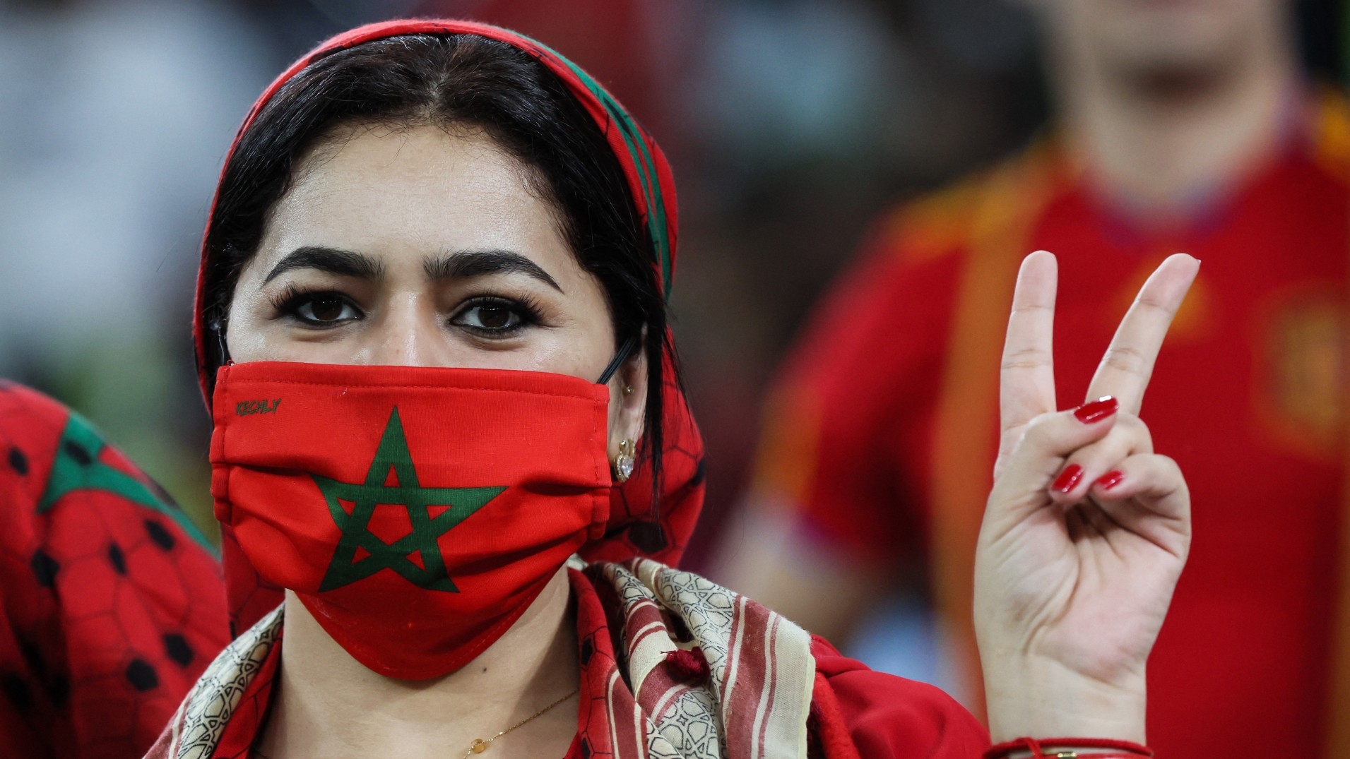 A Morocco supporter poses during the Qatar 2022 World Cup round of 16 football match against Spain in Al-Rayyan, west of Doha on 6 December 2022 (AFP)