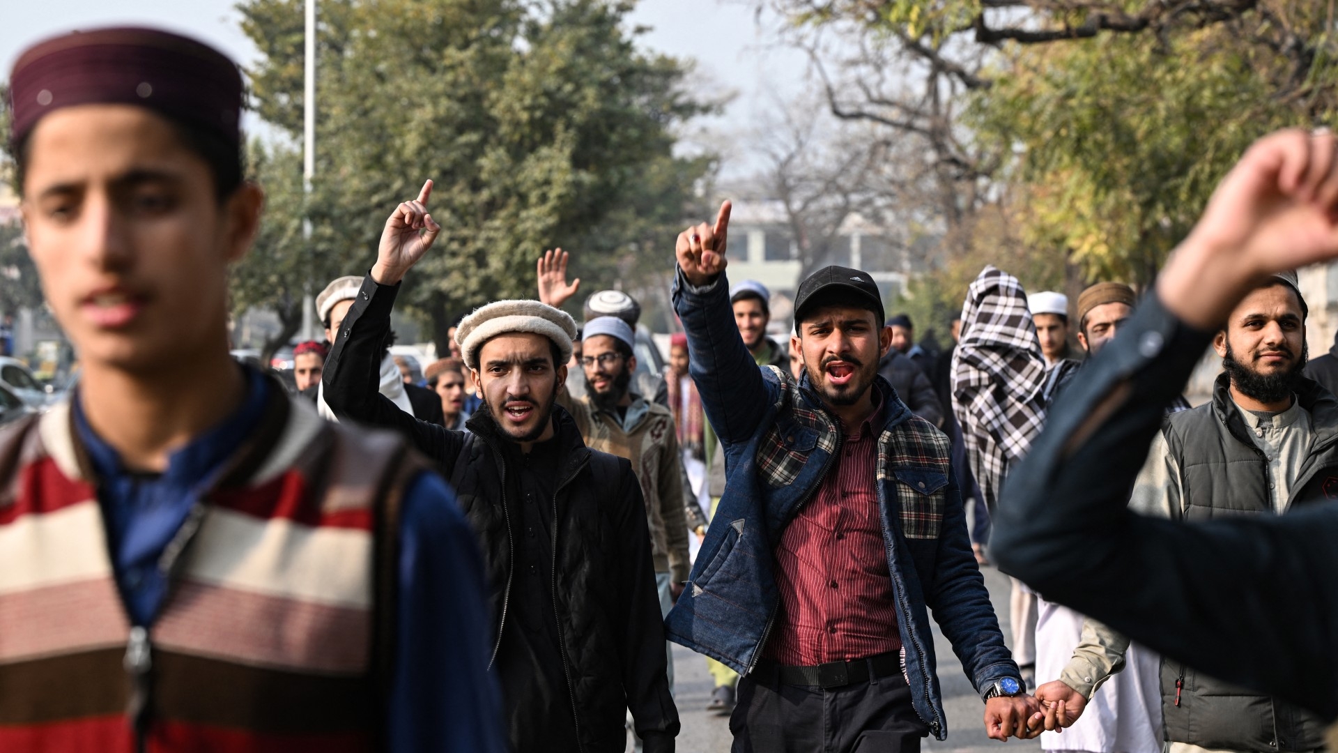 Youth activists of Muslim Talba Mahaz (MTM) shout slogans during a protest against Iranian air strike, in Islamabad on 18 January 2024 (AFP)