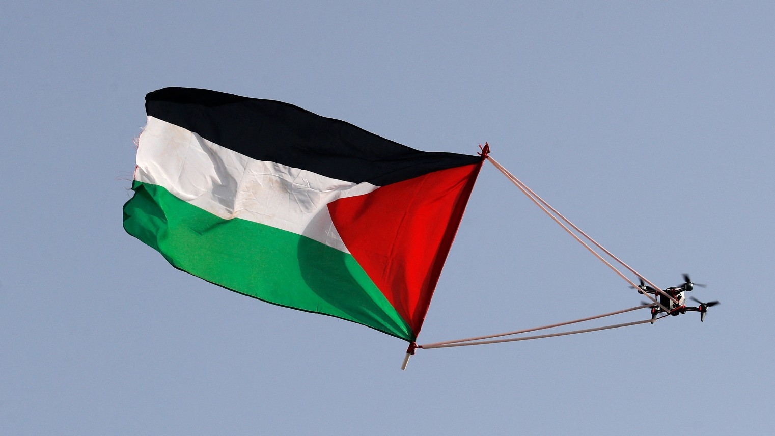 A Palestinian flag hanging from a civilian drone flies over Jerusalem during the Israeli 'flags march' to mark "Jerusalem Day" on 29 May, 2022 (AFP)