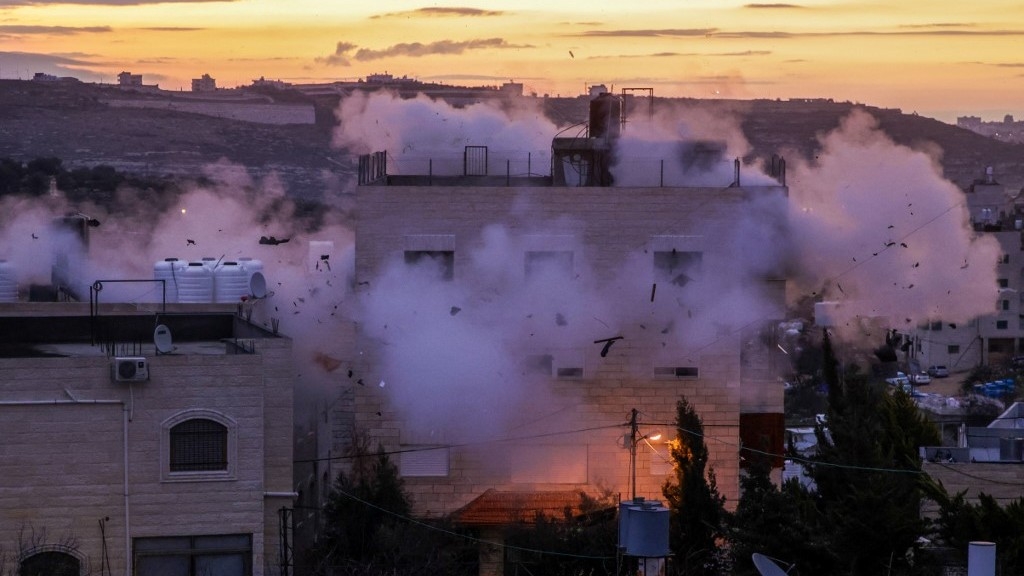 The residence of Mohammad al-Jaabari, a Palestinian who carried out a shooting attack last year, is demolished by Israeli forces in Hebron in the occupied West Bank early on 16 February 2023 (AFP)