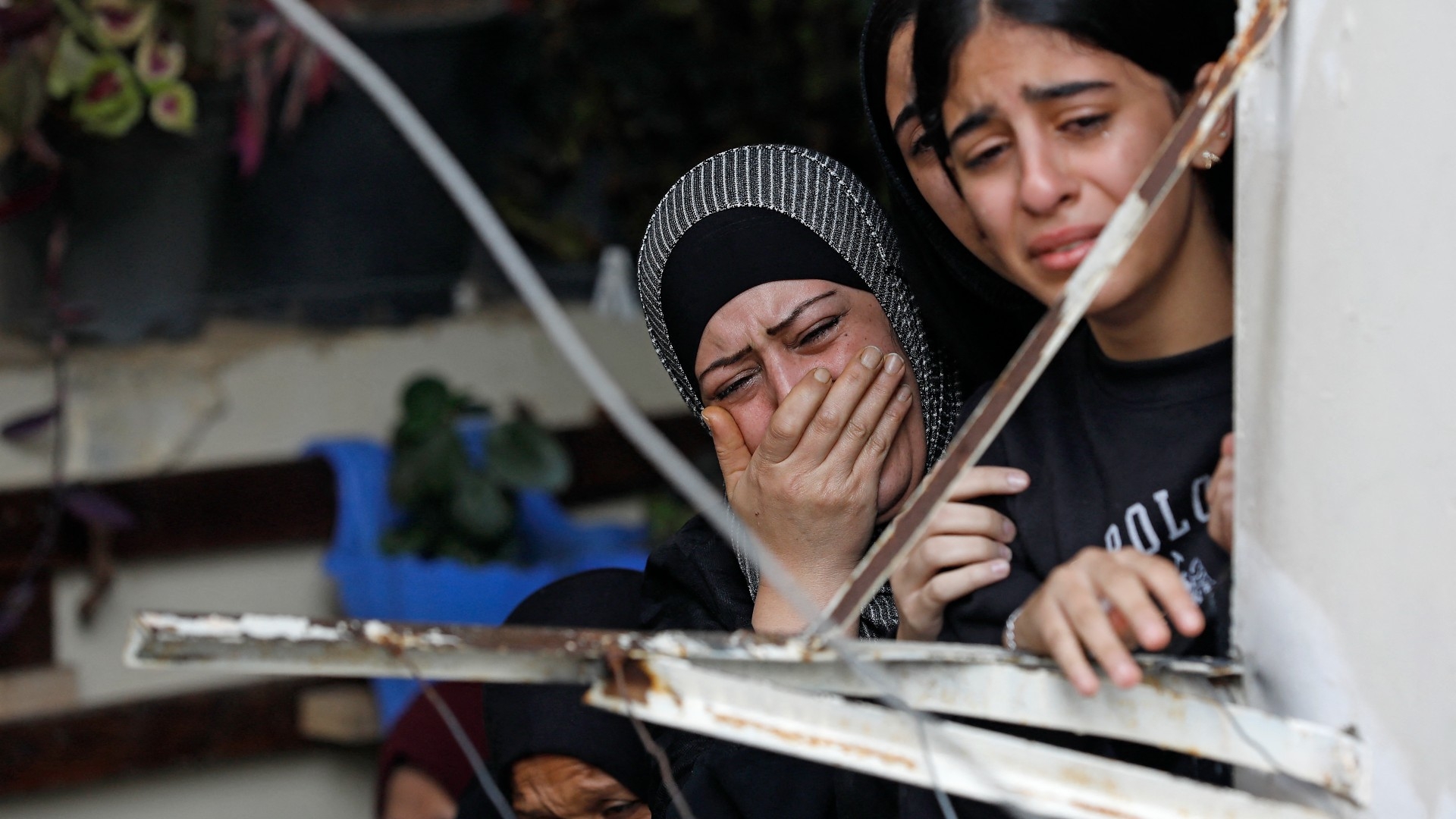 Palestinian relatives cry during a funeral procession in the city of Jenin, in the occupied West Bank on 8 December 2022 (AFP)