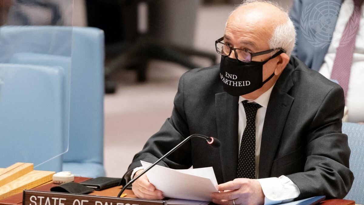 Palestinian ambassador to the UN Riyad Mansour wears a mask saying "End Apartheid" as he addresses a Security Council meeting in New York City on 23 February 2022.
