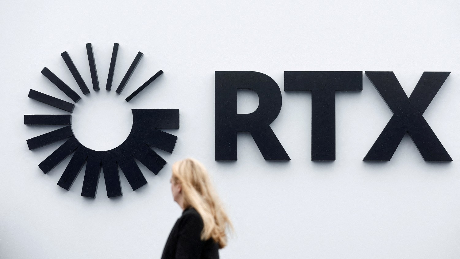 A visitor passes the Raytheon Technologies Corporation (RTX) logo at Le Bourget Airport near Paris, France, on 22 June 2023.