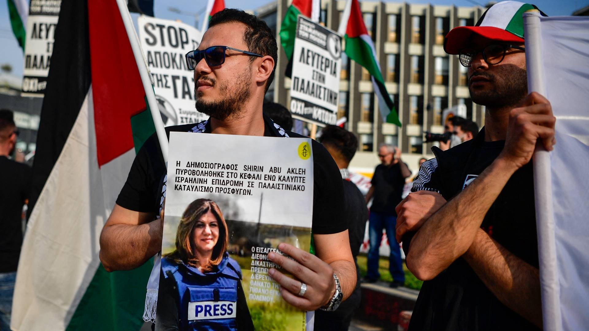 A protester holds a picture of slain Al Jazeera reporter Shireen Abu Akleh during a demonstration in front of the Israeli embassy to support Palestinians, in Athens on 15 May 2022.