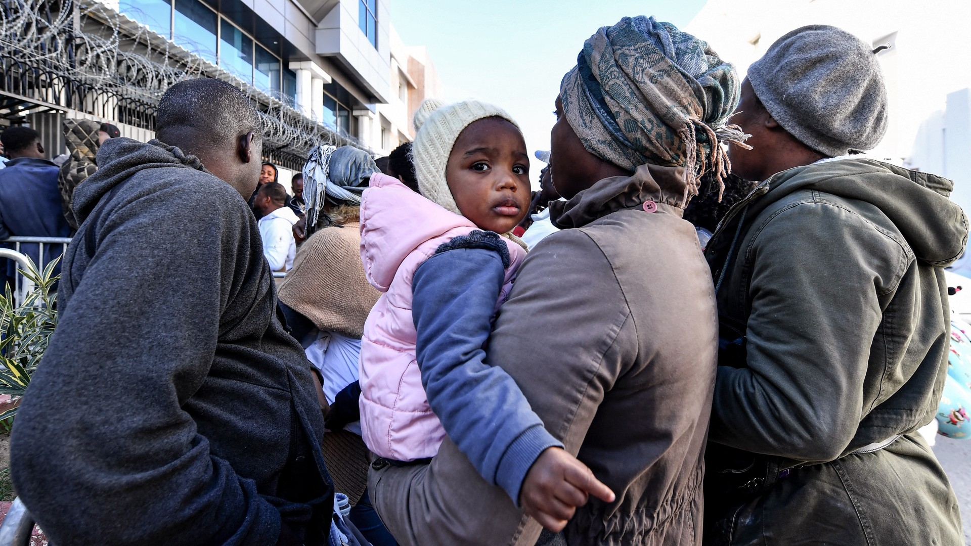 African migrants wait outside the offices of the United Nations High Commissioner for Refugees (UNHCR) in Tunis, Tunisia on 27 February 2023 (AFP)