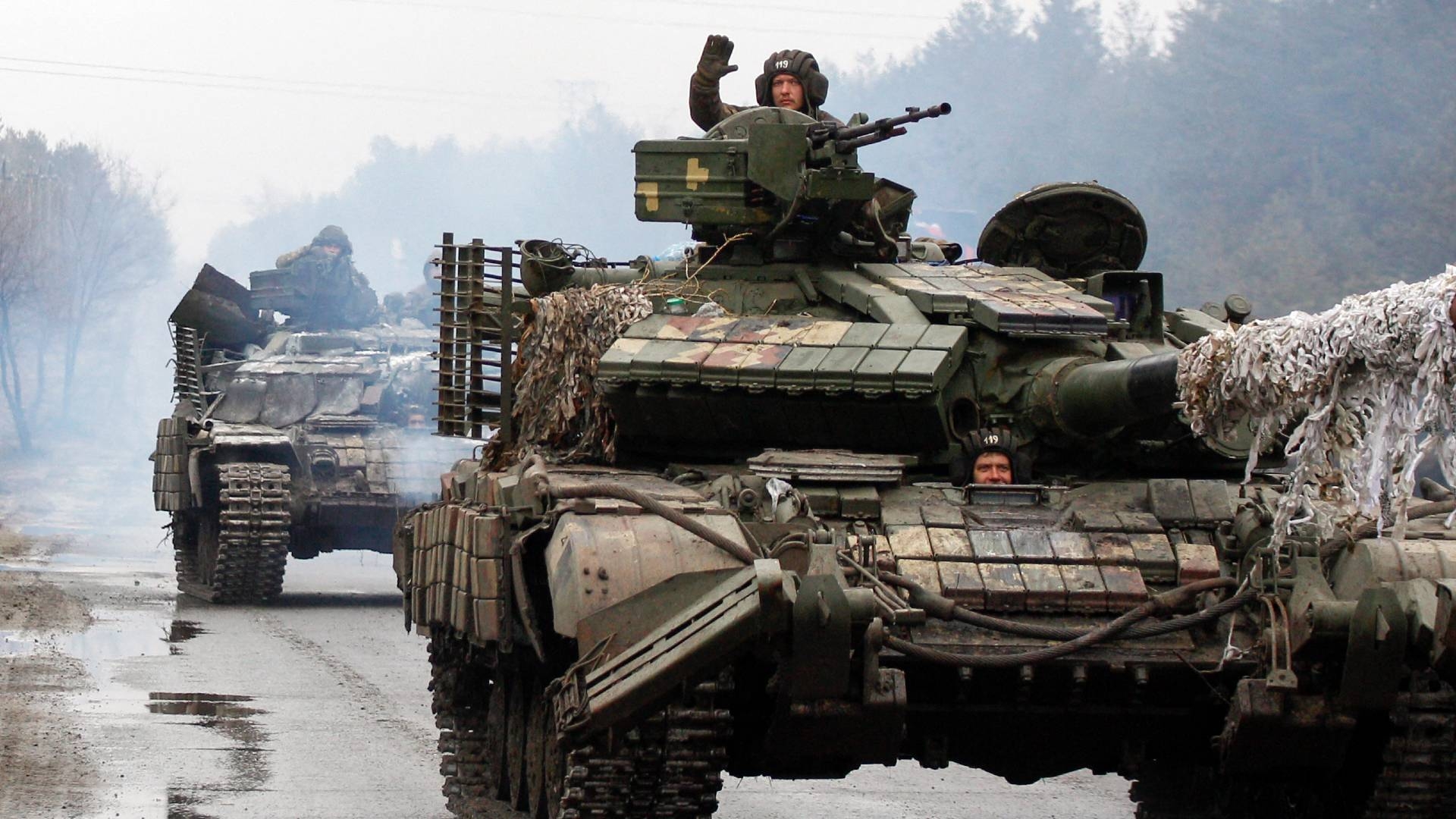 Ukrainian servicemen ride on tanks towards the front line with Russian forces in the Lugansk region of Ukraine on 25 February 2022.