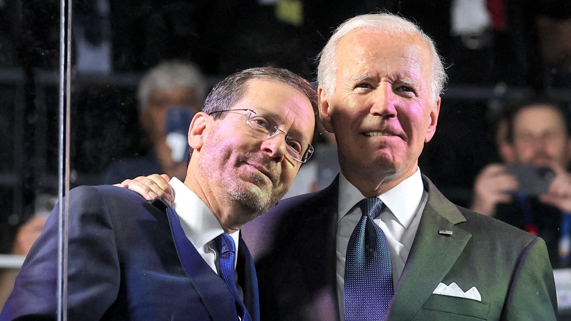 US President Joe Biden embraces Israel's President Isaac Herzog during the opening ceremony of the Maccabiah Games at Teddy Stadium in Jerusalem on 14 July 2022.