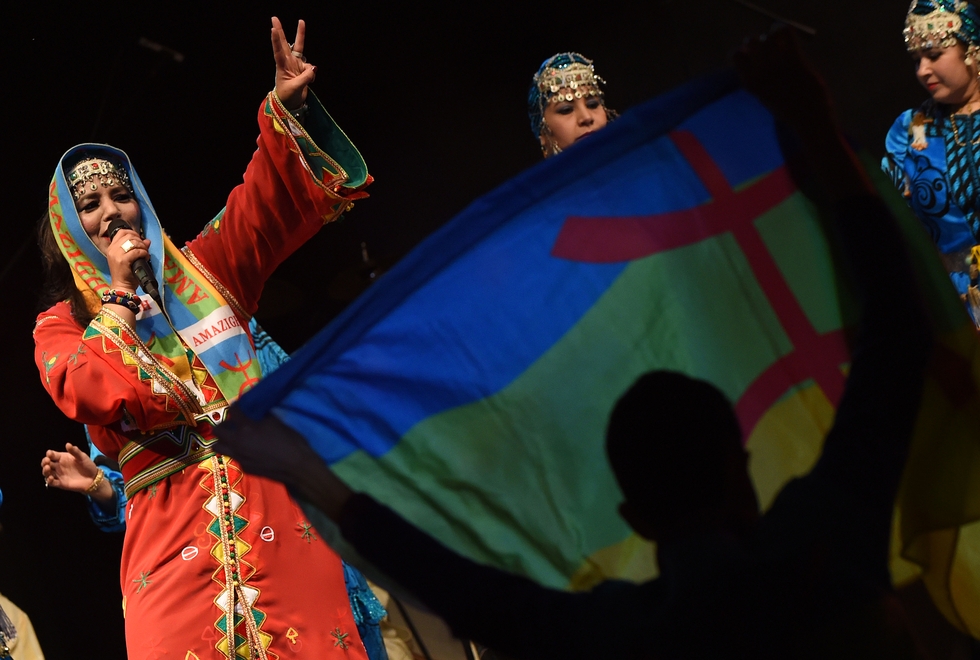 Amazigh singer Fatima Tabaamrant performs during a festival to celebrate the new year, showing the Amazigh flag in 2015 (AFP)