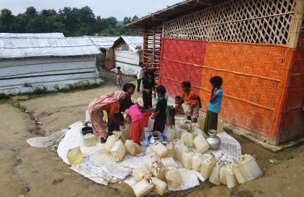 Rohingya refugees collect drinking water in the Unchiprang refugee camp, near Cox’s Bazar, in Bangladesh on 24 August (AFP) 