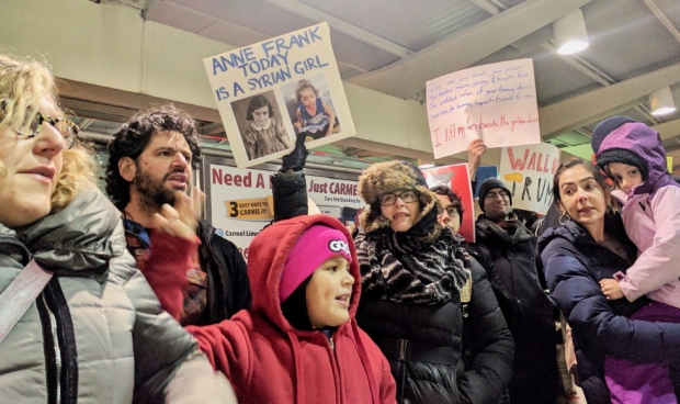 Protesters at JFK airport call for an end to the ban (MEE/Zainab Sultan)