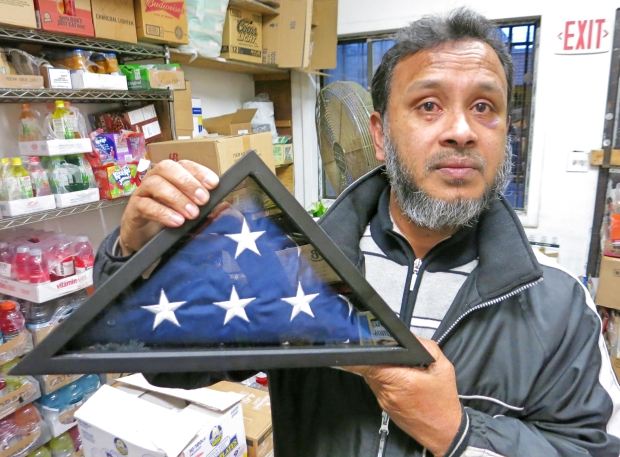Saker Haque with his tri-fold American flag (MEE/James Reinl)