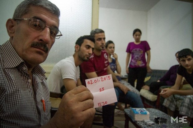 Nevin Omar's father shows the date of his interview with UNHCR (MEE/Xander Stockmans)