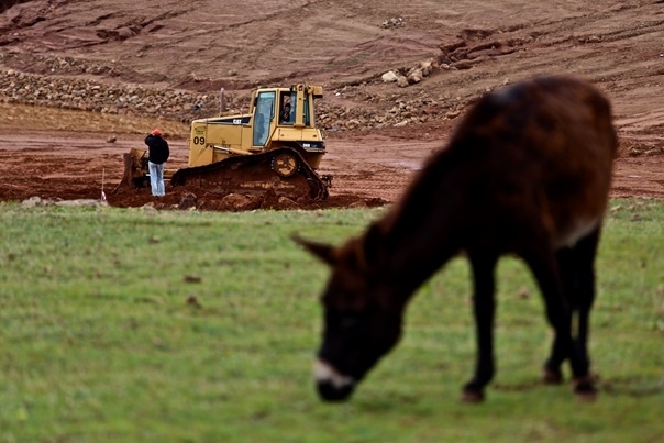 Bulldozers clear the land in the distance that has been confiscated for development (MEE/Nadir Bouhmouch)