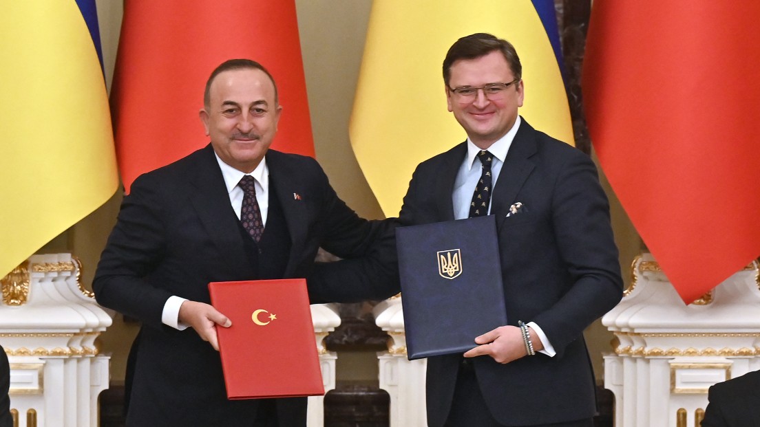 Ukraine's President Volodymyr Zelensky (R) and his Turkish counterpart Recep Tayyip Erdogan (L) applaud as Foreign Minister of Ukraine Dmytro Kuleba (2R) and his counterpart Mevlut Cavusoglu (2L) exchange folders with signed documents in Kyiv on February 3, 2022. 