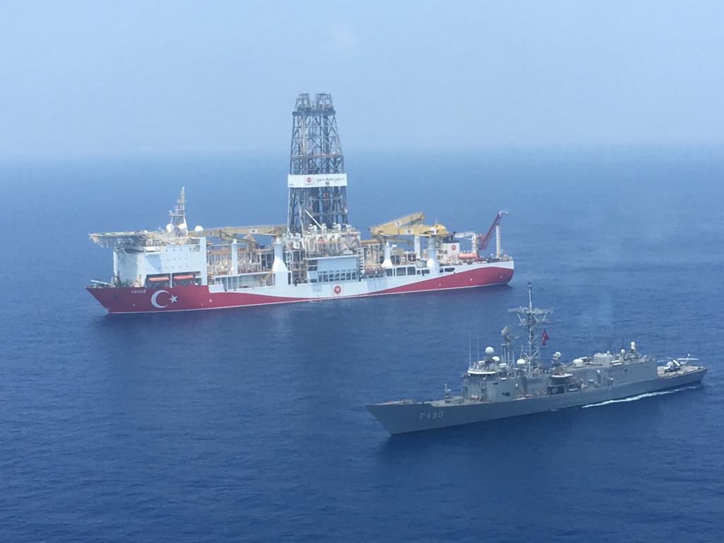 A Turkish Navy warship patrols next to Turkey’s drilling ship, dispatched towards the eastern Mediterranean near Cyprus (Turkish Defence Ministry/AFP)