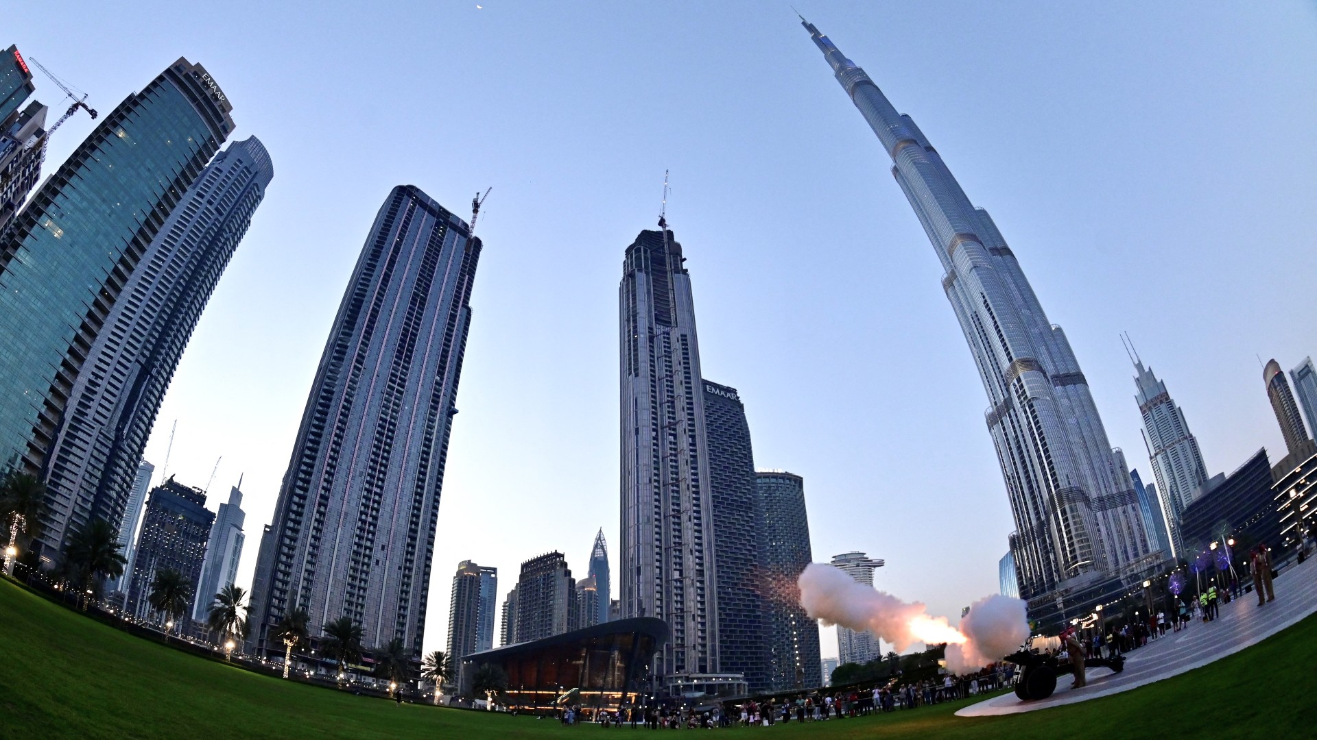 a military cannon firing to signal sunset marking the end of the fasting day for Muslims observing Ramadan in front of Burj Khalifa in Downtown Dubai on April 7, 2022 (AFP)