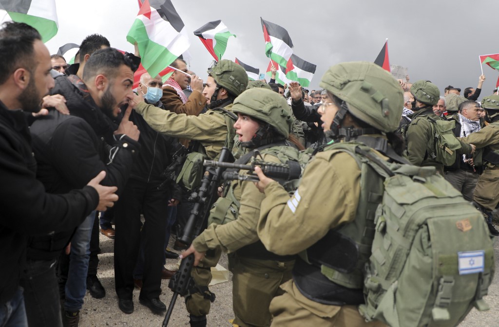 Palestinian demonstrators confront Israeli soldiers near the West Bank village of Tubas on 29 January (AFP)