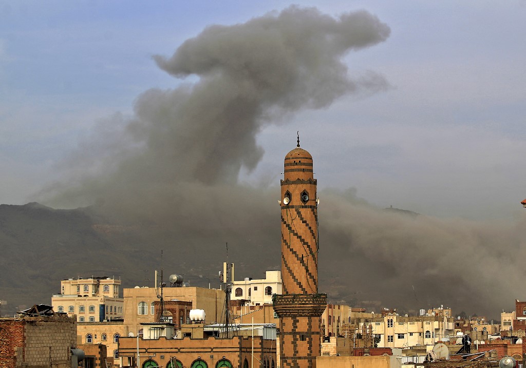 Smoke billows after an air strike in Sanaa on 16 June 2020 (AFP)