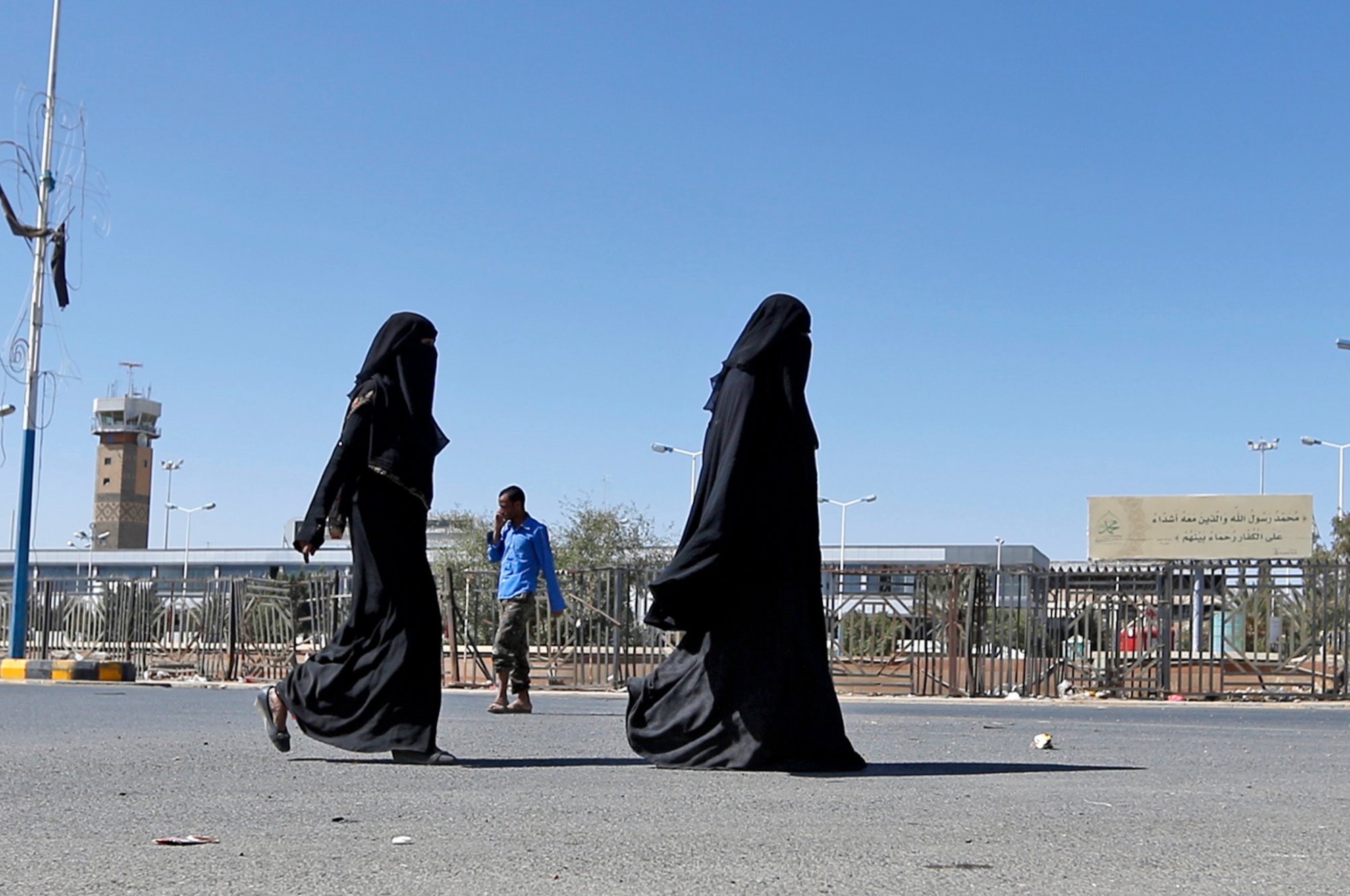 Yemeni women walk outside the international airport in the capital Sanaa on 23 November 2017 (AFP)